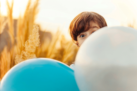 Kid Holding Two Balloons