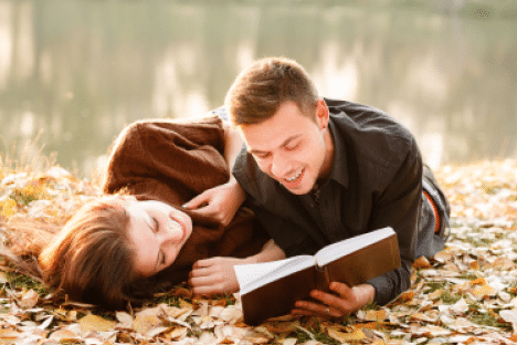 Man and Woman Reading on the Ground